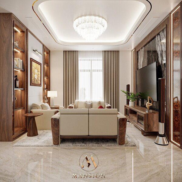 Phòng khách Mansion thiết kế với tủ trang trí, kệ tivi gỗ óc chó trên nền tường kem, sàn đá sáng màu và sofa màu kem